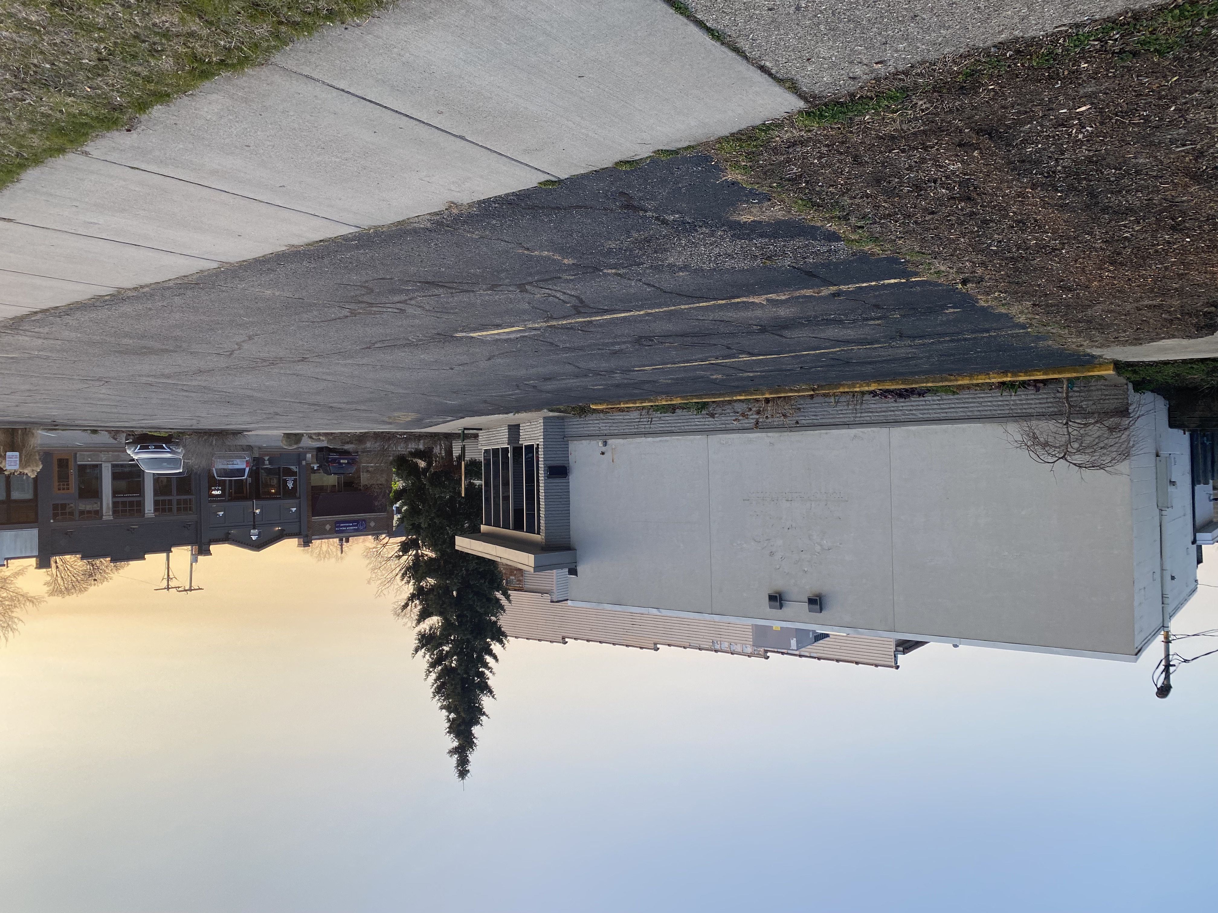 an empty parking lot in front of a building